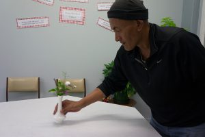 Volunteer Fabian setting tables for guests. 