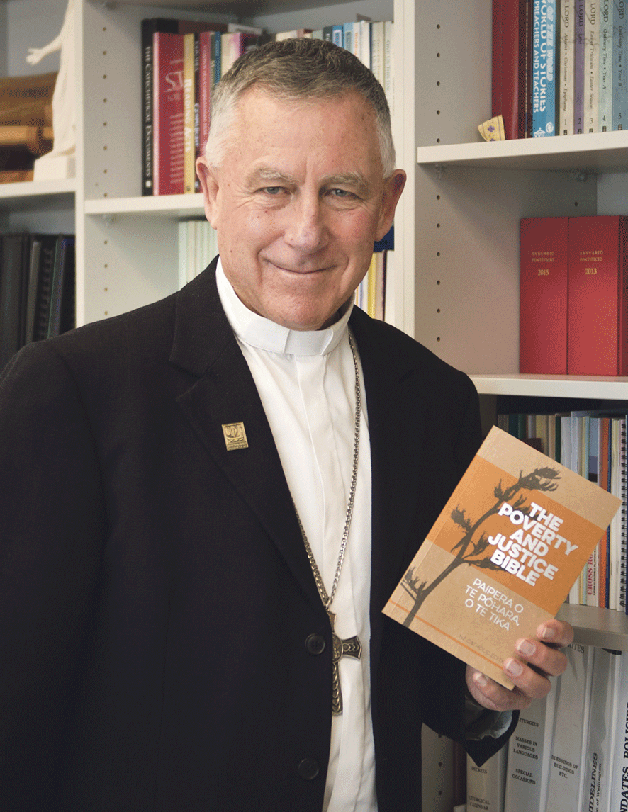 Cardinal John Dew with a copy of The Poverty and Justice Bible, to be launched on 13 September at the start of Social Justice Week