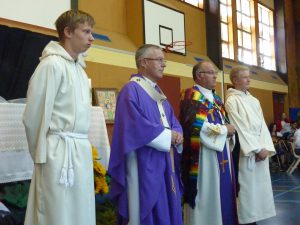 Receiving the gifts, from left: Jared Lautenslager, Cardinal John Dew, Fr Bill Warwick. 