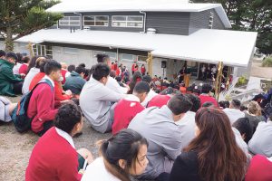 Students watch opening and blessing. 