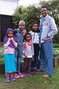 Standing proudly in front of the vegetable garden they have planted at the Island Bay house is Abdiasiis from Somalia with four of his children. From left: Satiro (6), Maandeeg (10), Fatiad (5), Mohamed (10) and Abdiasiis. Photo: Annette Scullion