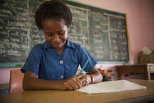 Paulina Dulaki Naleba (10) finds some comfort and relief writing about her experiences of Cyclone Winston. Photo: Crispin Anderlini/Caritas