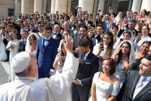 Pope Francis greets newly married couples during his general audience in St Peter’s Square at the Vatican on 30 September 2015. Photo: Creative Commons/CNS.