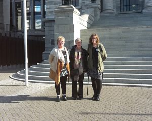 Outside parliament are (l–r) Teresa Homan, Lesley Hooper, and Lisa Beech. 