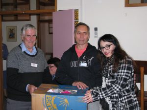 ‘Instruments of Mercy’ in action, (l–r) Fr Phil Cody sm and Wawata Johnson present school materials on behalf of Ōtaki Print and Railway Bookshop to Tayyaba Khan, CEO of Changemakers Refugee Forum. Photo: Rowan Donoghue sm.