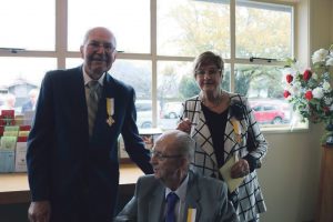 Gordon and Linda Holmes and Pat Hewson (seated) receive papal award for Church dedication. 