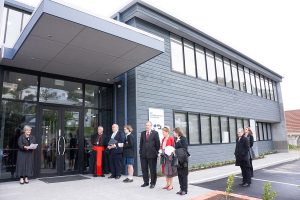 Outside the new administration and learning centre, Principal Mrs Mary Curran welcomes Cardinal John Dew and other guests.