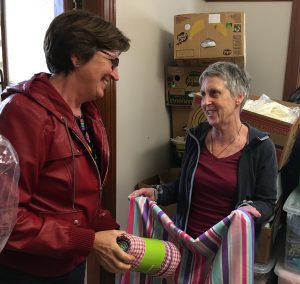 Lesley Hooper and Brendy Weir of Wellington Catholic social services sort linen donated to stock homes for former refugees arriving in Wellington. Photo: Supplied 